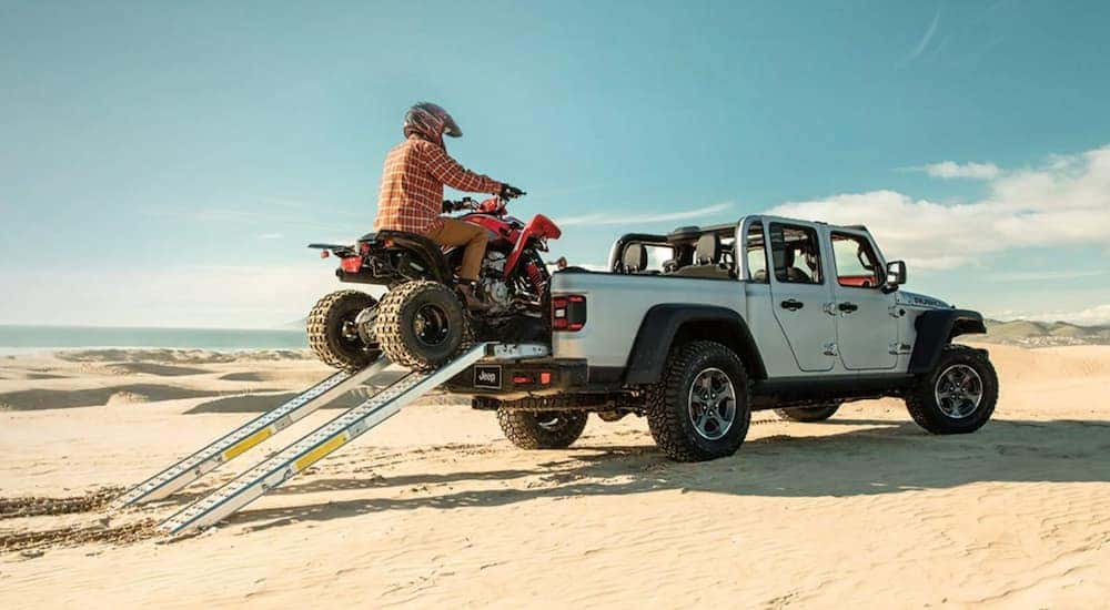 A silver 2021 Jeep Gladiator is shown from the rear at an angle.