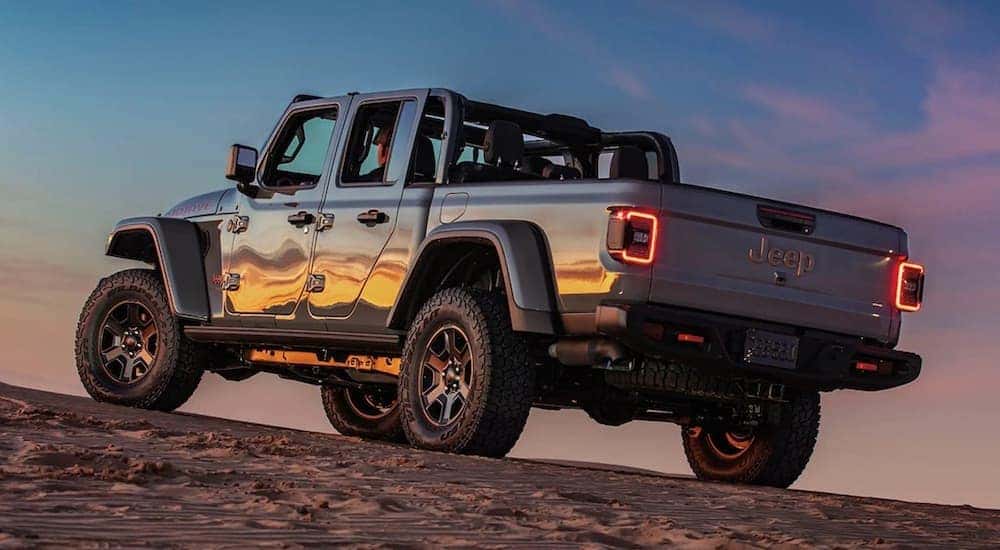 A grey 2023 Jeep Gladiator is shown from the rear at an angle.