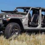 A silver 2023 Jeep Gladiator Rubicon is shown from the side while off-road after leaving a dealer that has a Jeep Gladiator for sale.