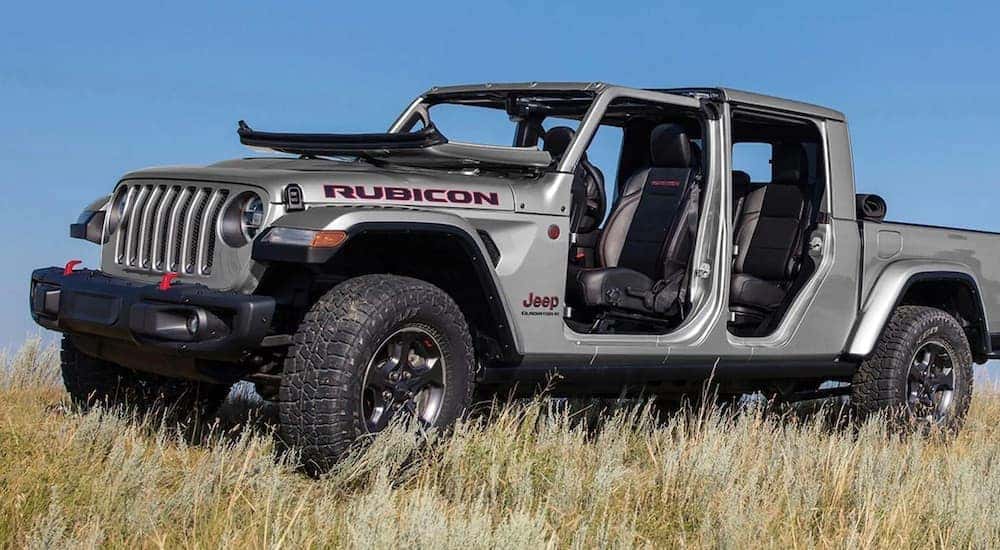 A silver 2023 Jeep Gladiator Rubicon is shown from the side while off-road after leaving a dealer that has a Jeep Gladiator for sale.