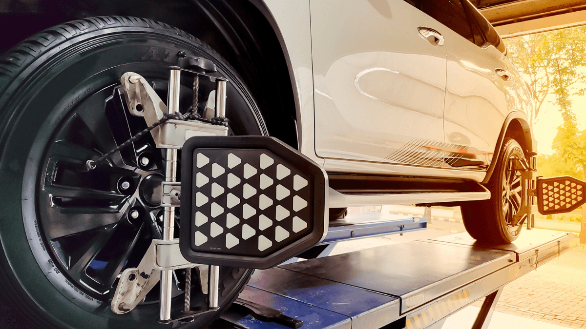 White car being prepared for wheel alignment