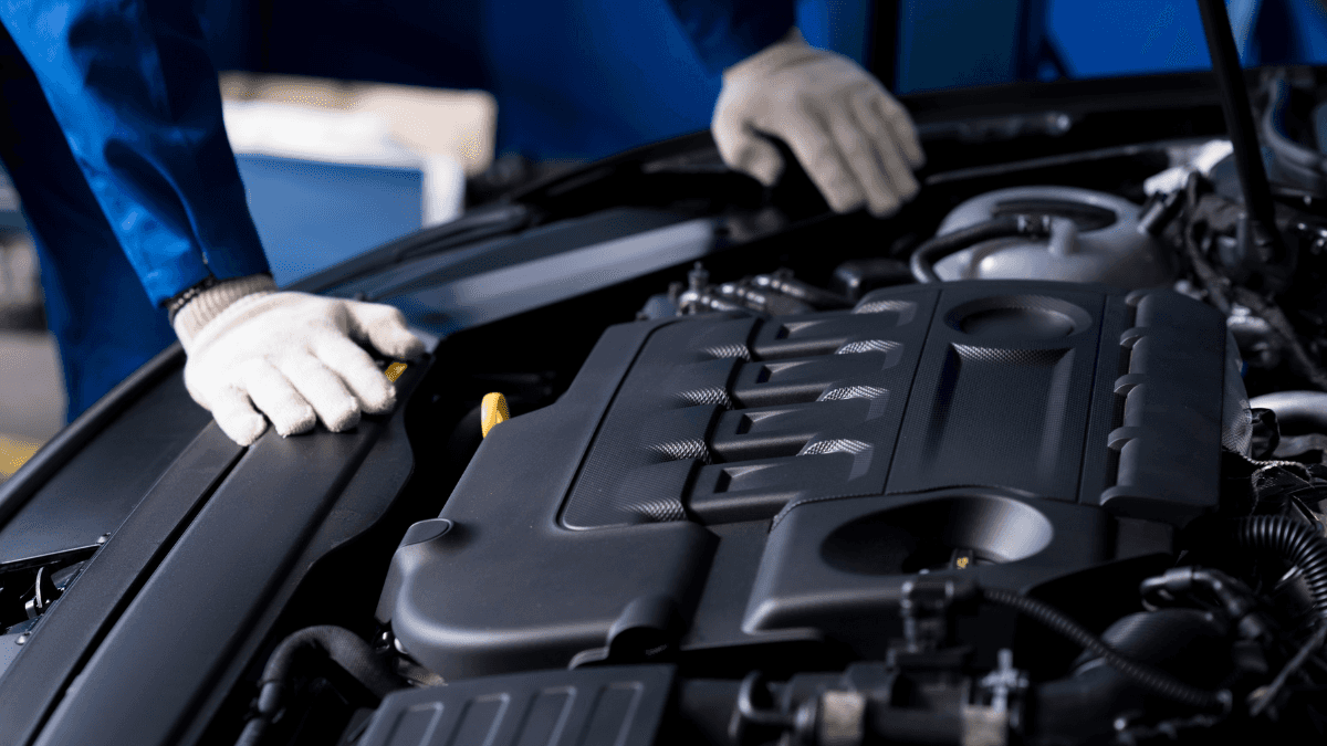 An engineer examining a vehicle's engine