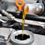 Motor oil being poured into a vehicle