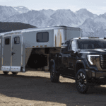 2024 GMC Sierra HD towing a trailer in a mountainous area