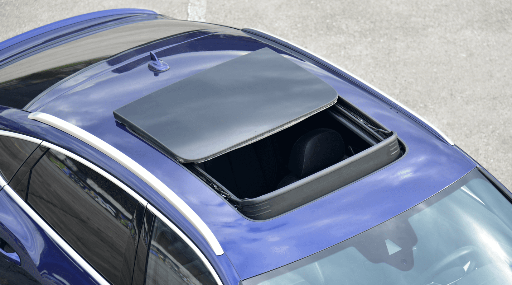 A blue car with an open sunroof