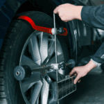 A mechanic performing a wheel alignment on a vehicle