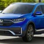 A blue 2022 Honda CR-V is shown from the front at an angle after leaving a Minot Honda dealership.