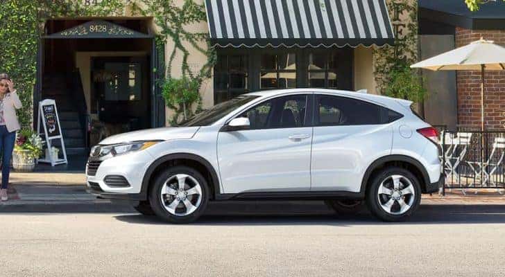 A white 2022 Honda HR-V LX is shown from the side on a city street.
