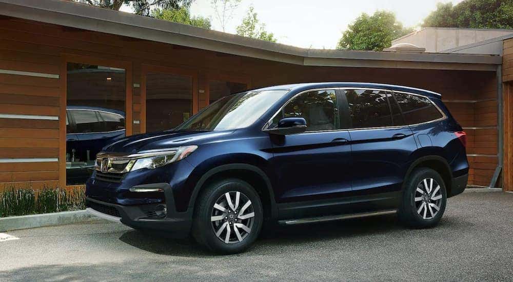 A blue 2022 Honda Pilot is shown from the front at an angle.