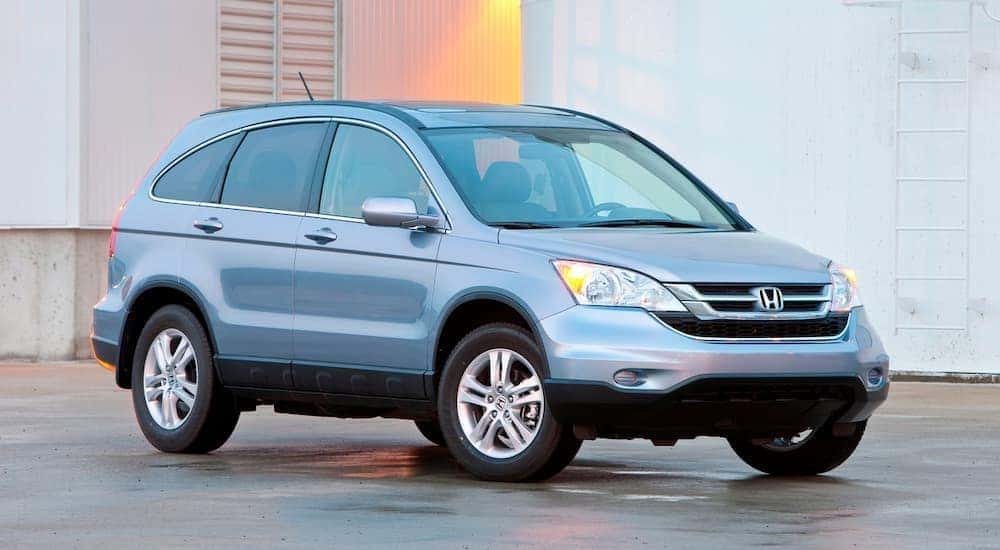 A blue 2011 Honda CR-V is shown from the front at an angle after leaving a dealer that had a used Honda CR-V for sale.