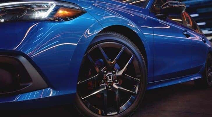 The front wheel of a 2022 Honda Civic Sedan is shown in close up after leaving a dealer that has a Honda Civic for sale.