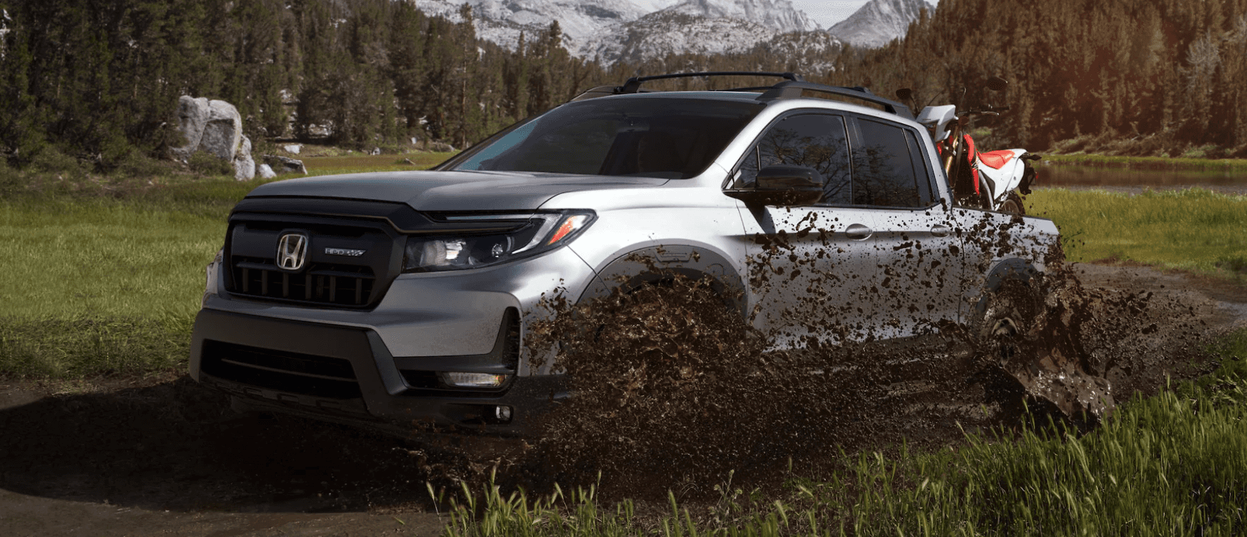 2024 Honda Ridgeline driving through mud and grass