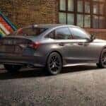A gray Honda Civic parked in an alley