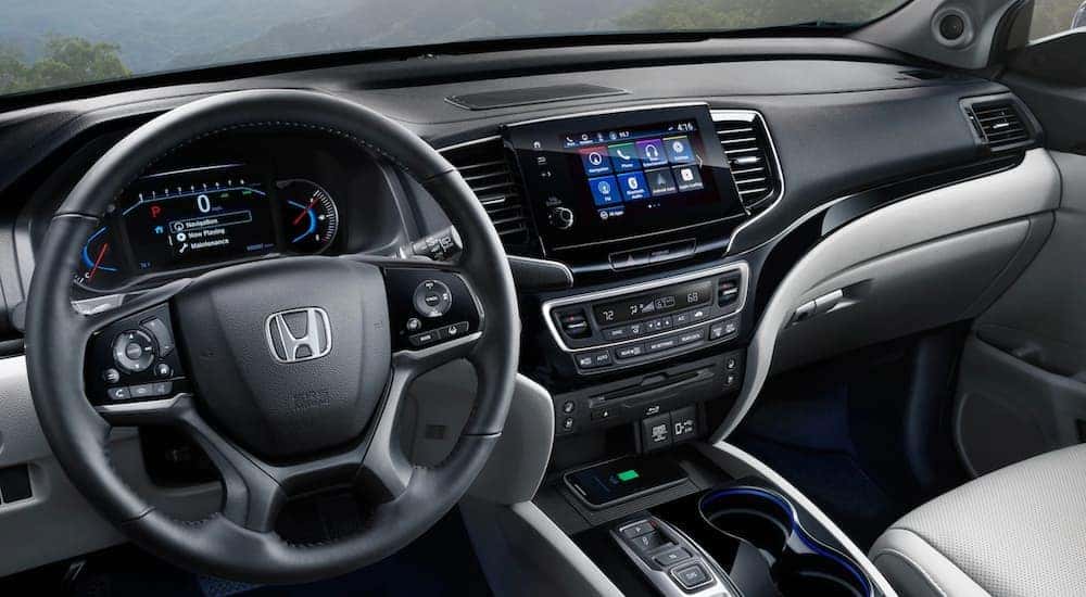 The black and grey interior of a 2020 Honda Pilot at a used Honda dealership