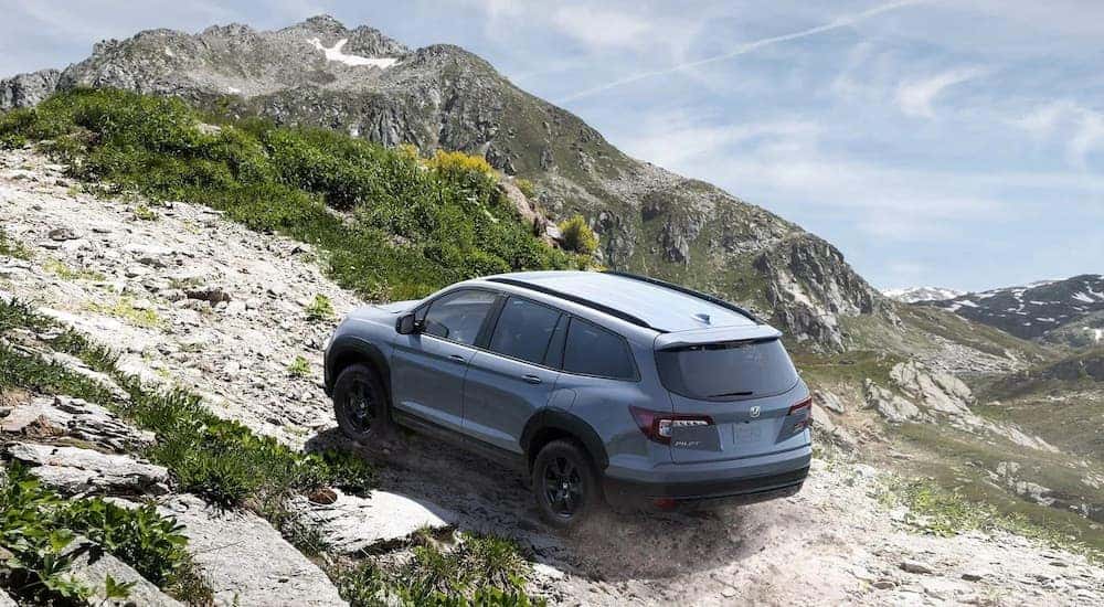 A grey 2022 Honda Pilot Trailsport is shown from the rear at a high angle after leaving a Honda dealer near me.