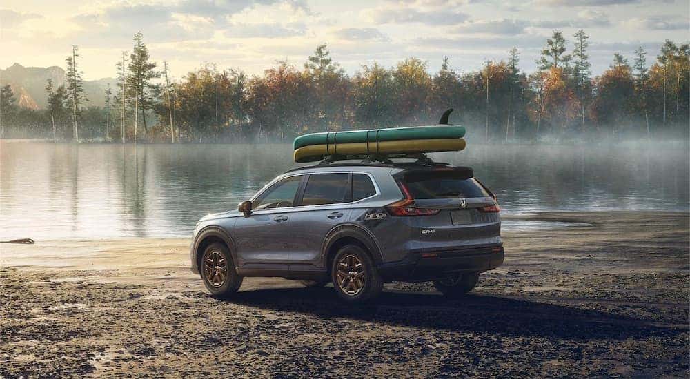 A grey 2023 Honda CR-V is shown from the rear at an angle after leaving a Honda dealer near New Town.