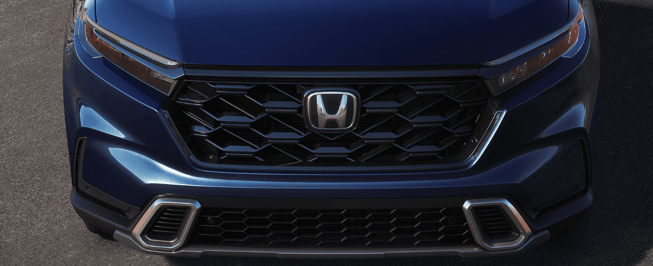 Close-up view of the 2025 Honda CR-V Sport Touring Hybrid hood and front grille
