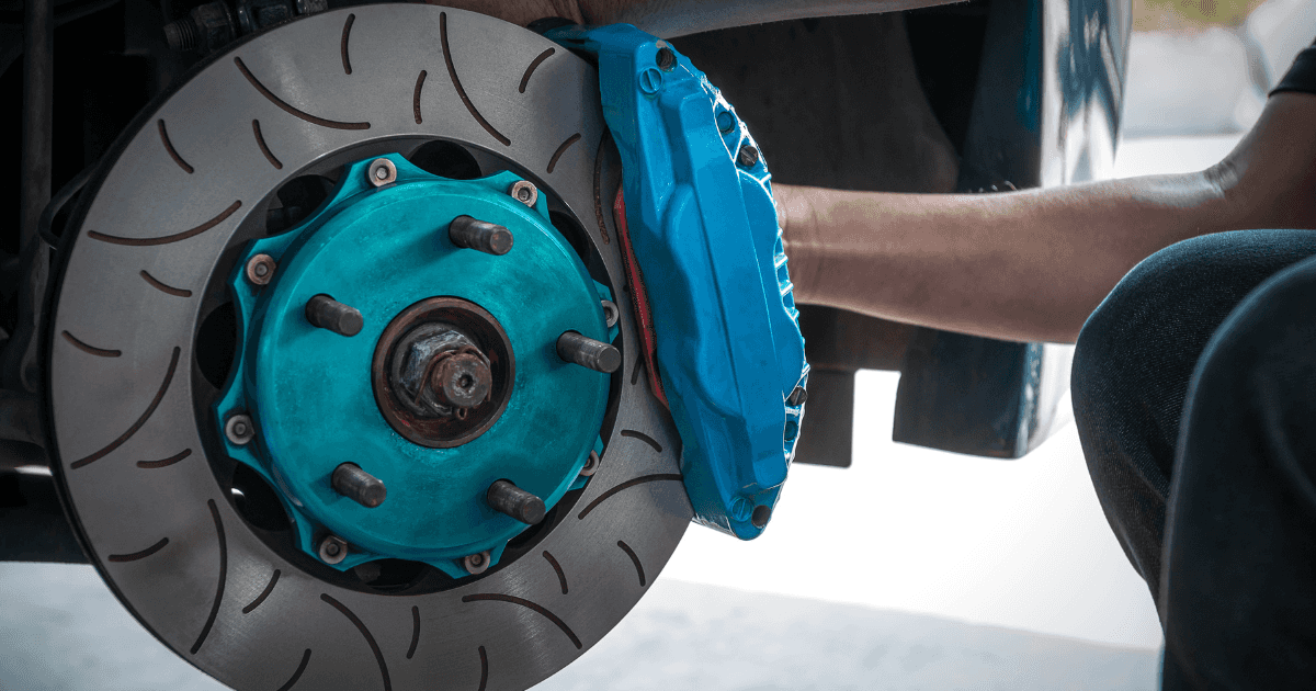 A technician repairing a vehicle's brakes