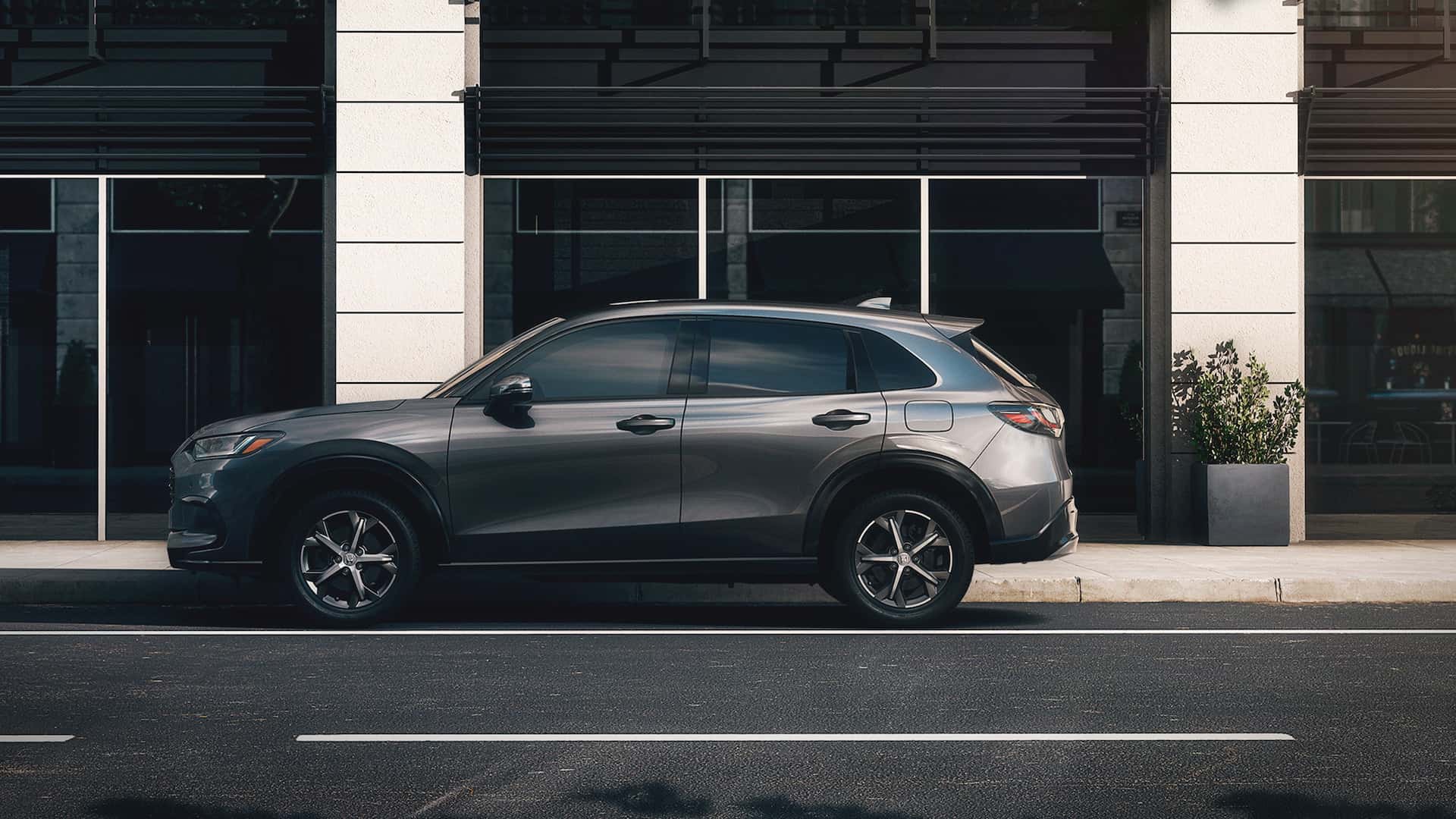 A gray 2025 Honda HR-V parked on the side of the street.