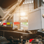 A technician replacing a vehicle's battery