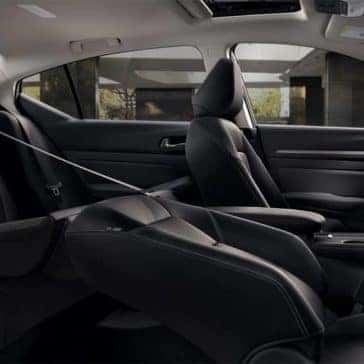 Passenger seats folded down inside a 2020 Nissan Altima