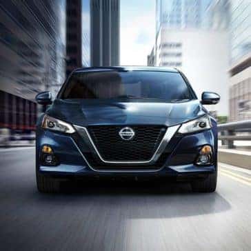 Front view of a black 2020 Nissan Altima V driving through the city