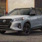 A grey 2022 Nissan Kicks is shown in front of a shop after leaving a Nissan Dealer near you.