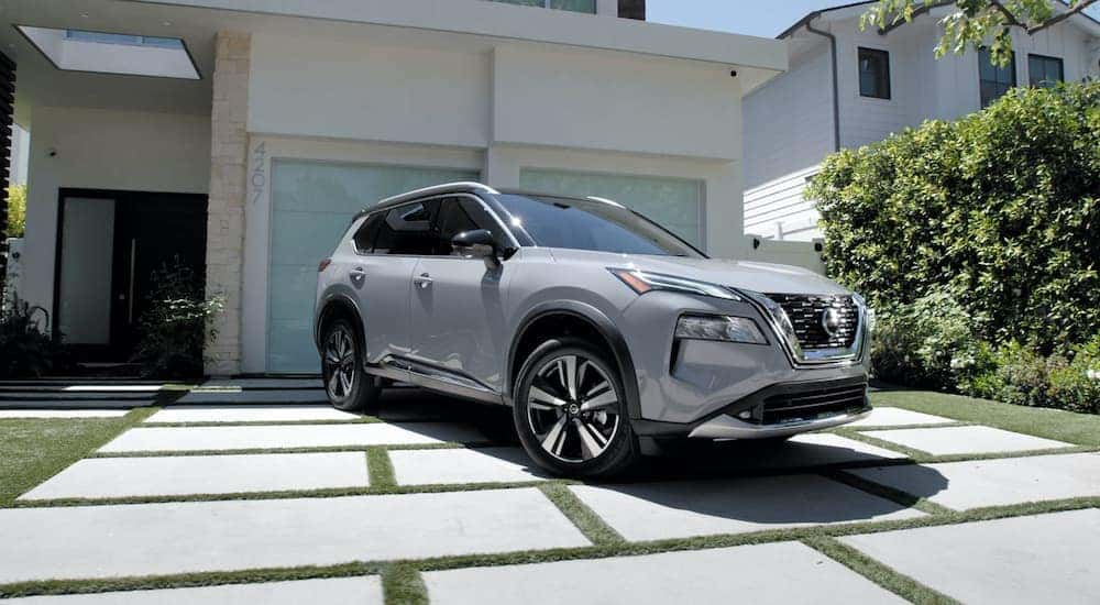 A silver 2022 Nissan Rogue S is shown parked in a driveway.