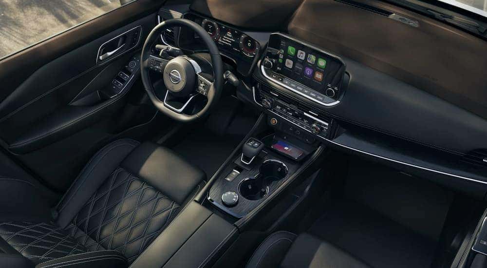 The black interior of a 2022 Nissan Rogue is shown at a Nissan Rogue dealer.