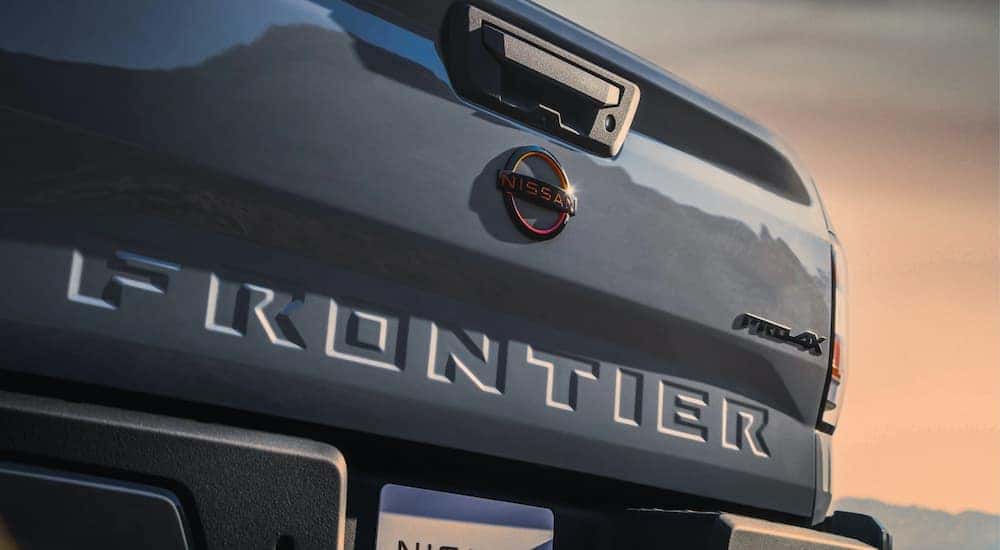 A close up of rear liftgate of a grey 2023 Nissan Frontier PRO-4X is shown.