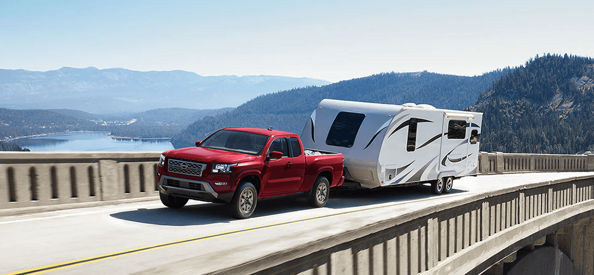 2024 Nissan Frontier towing a trailer on a bridge