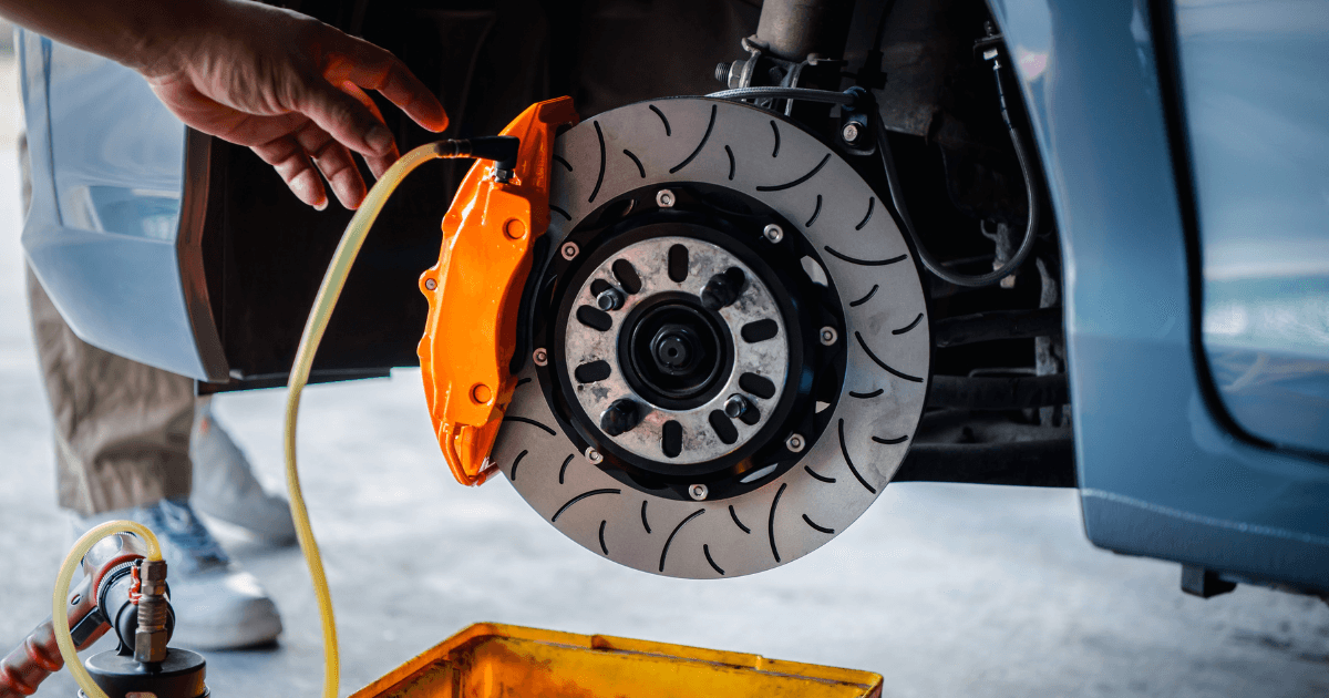 A technician performing vehicle brake repair service
