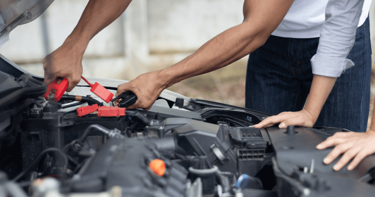 A pair of engineers jumpstarting an engine