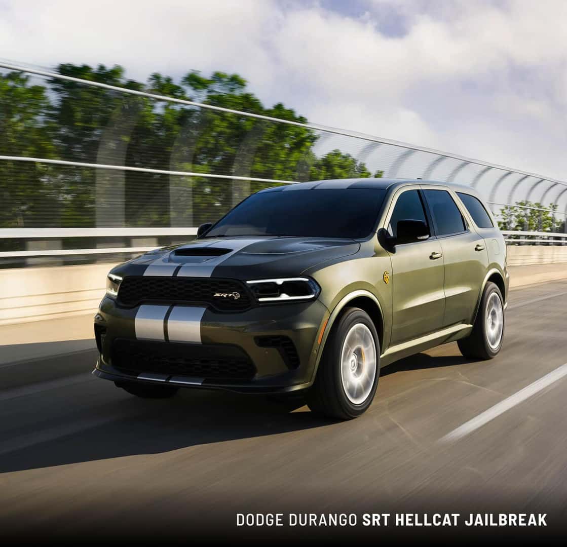 Front three-quarter view of a green 2027 Dodge Durango SRT Hellcat Jailbreak on a highway.