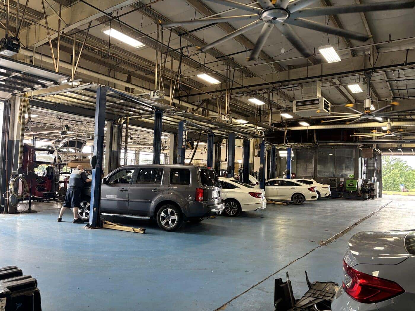 Wide view of the service bay with vehicles on lifts