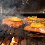 Salmon topped with lemon on the grill
