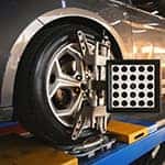 Car wheel alignment is in progress. auto camber toe check fixing. sensor during suspension adjustment and automobile wheel alignment work at the repair service station