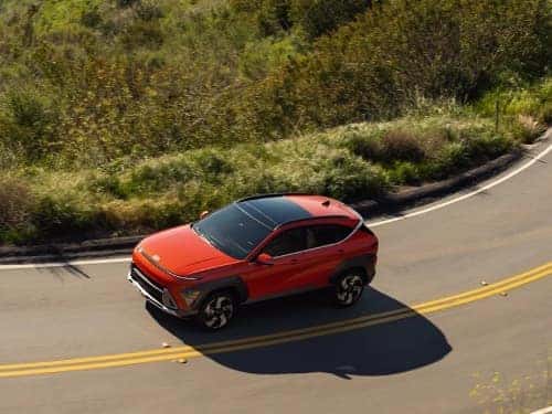 2025 Hyundai KONA overhead view of vehicle driving around a curve on a highway