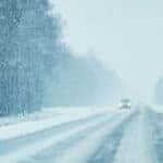 A car driving on a snowy road