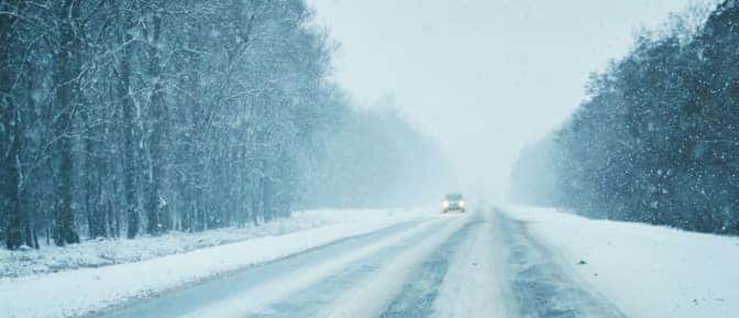 A car driving on a snowy road