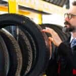 A person holding a tire.