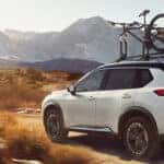 A white car with a bike on top
