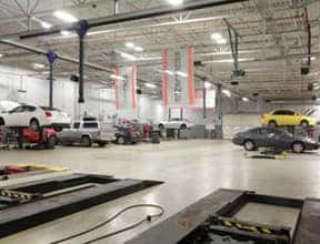 A large garage with cars in it