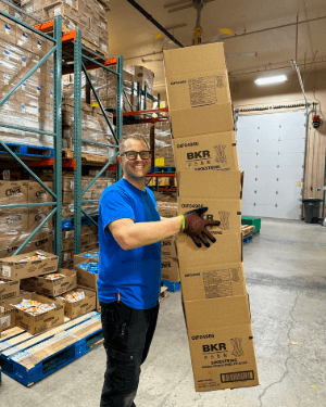 A person holding a stack of boxes