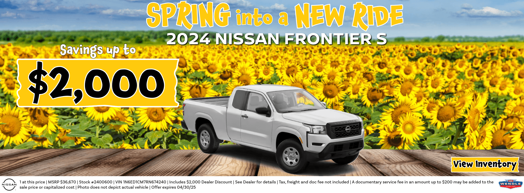 A truck parked in front of a field of sunflowers