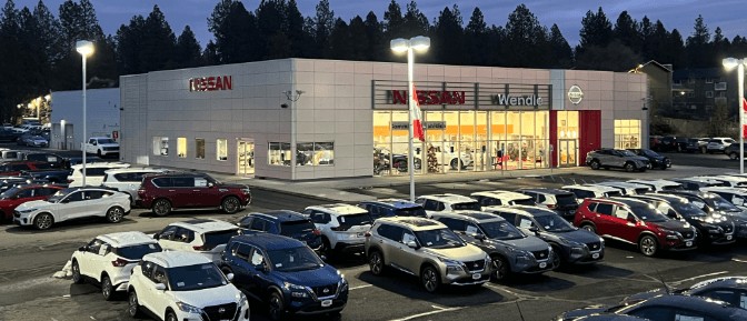 Rows of cars parked in front of a building