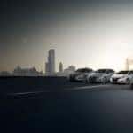 Nissan model lineup parked with a city skyline shown in the background