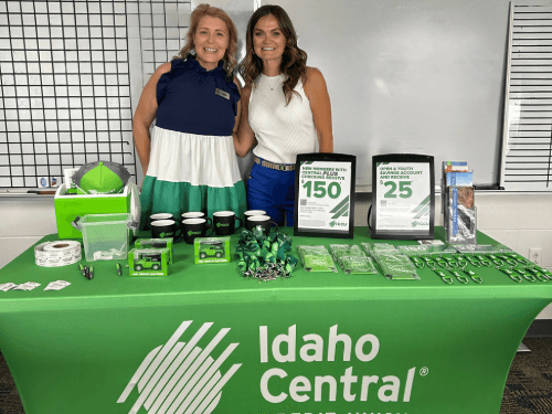 Two women standing next to a table