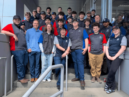Group photo of NEWTech Prep Auto Department students and instructor during a tour.