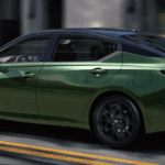 Side profile of a metallic green Nissan Altima SR driving on a city street.